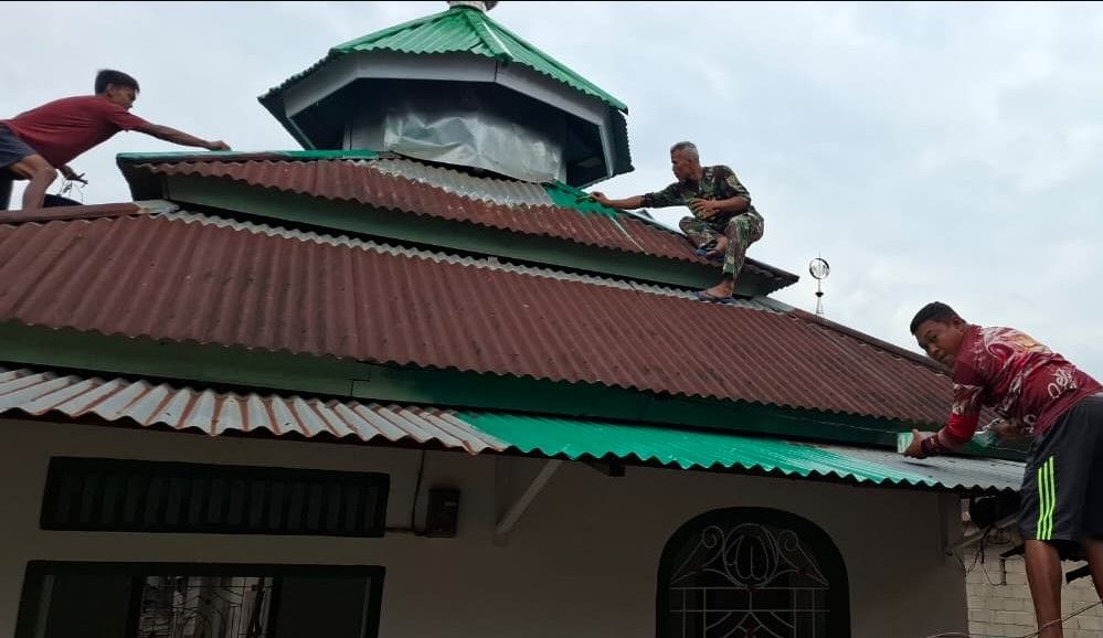 Satgas TMMD Ke-129 Kodim 0416/Bute bersama warga mengecat Langgar Al-Hikmah Desa Tanjung Agung.(poto: jambiprima.com).